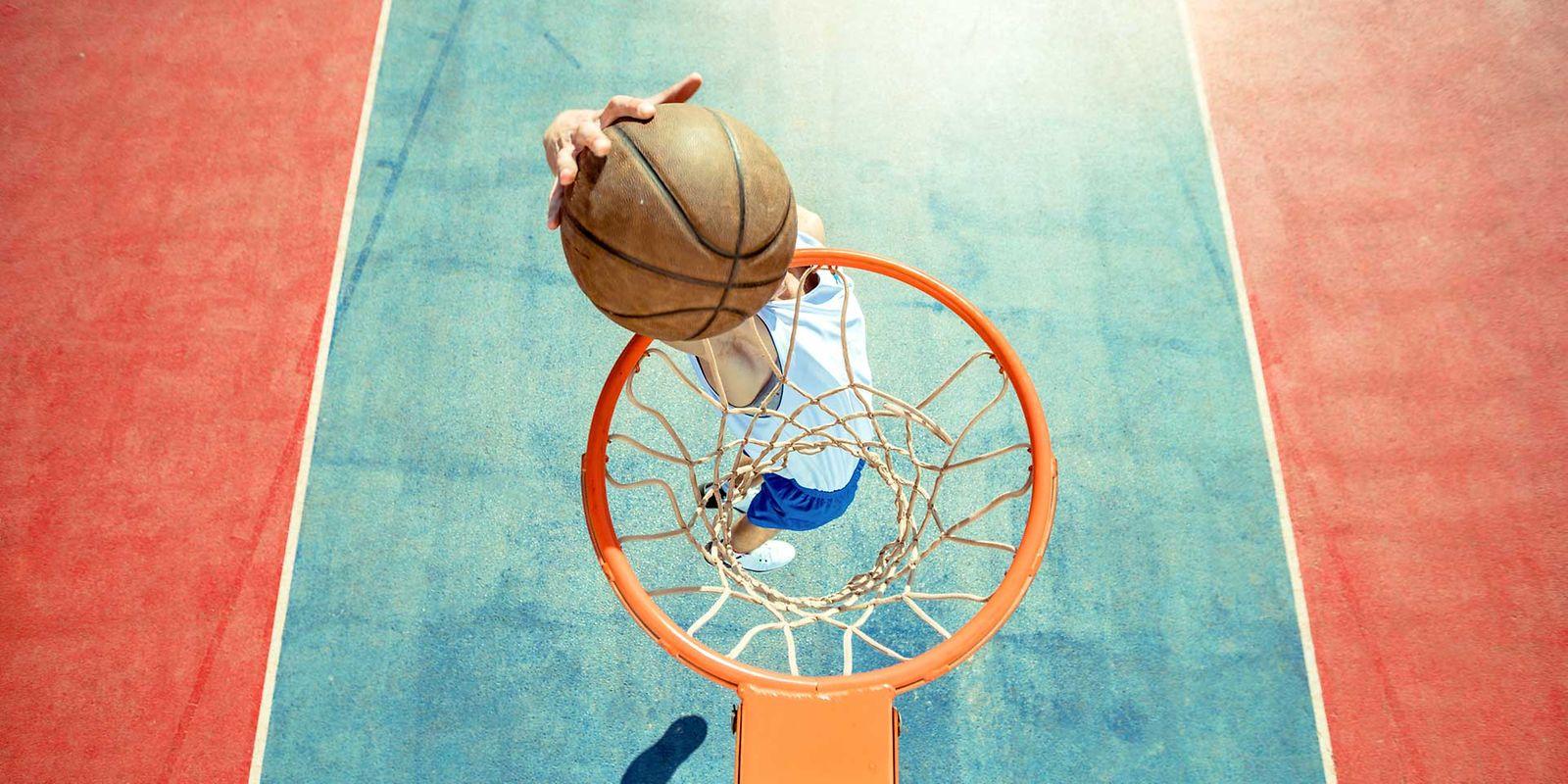 Bonus für fitte Azubis: Junger Mann macht einen Slam Dunk